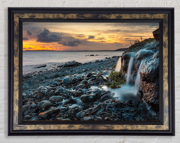 Water flows down the rocks into the sea