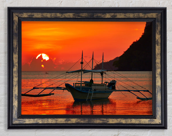 Boat sailing in the orange sunset