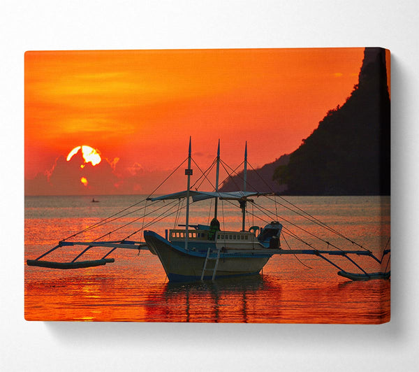 Boat sailing in the orange sunset