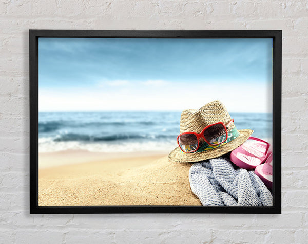 Sun hat and sunglasses on the beach