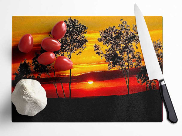 Red Sunrise Through The Trees Glass Chopping Board