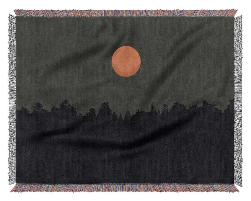 The Red Sun Over The Grey Treeline Woven Blanket