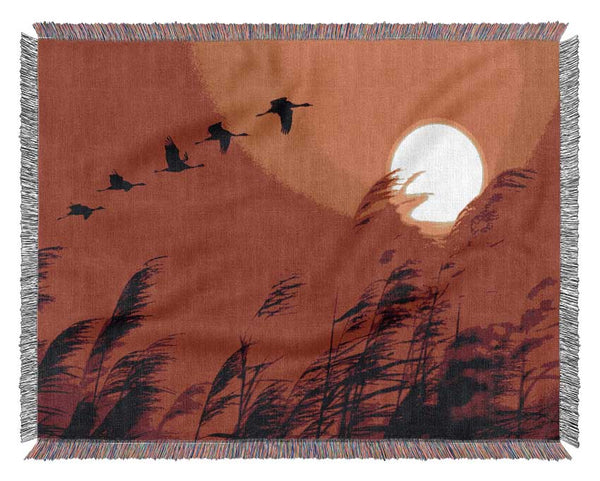 Geese In Flight Under The Red Sun Woven Blanket