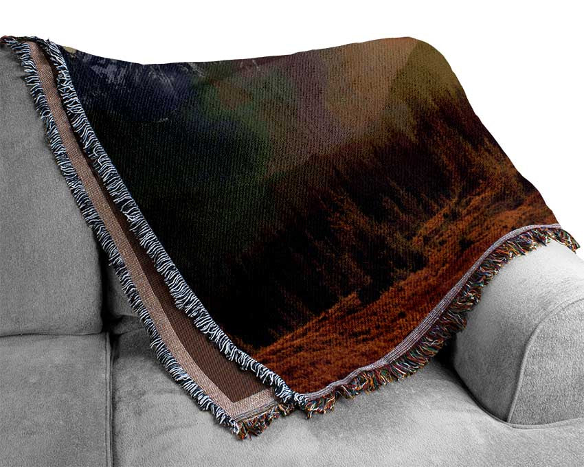 Tall mountains in the sunset Woven Blanket