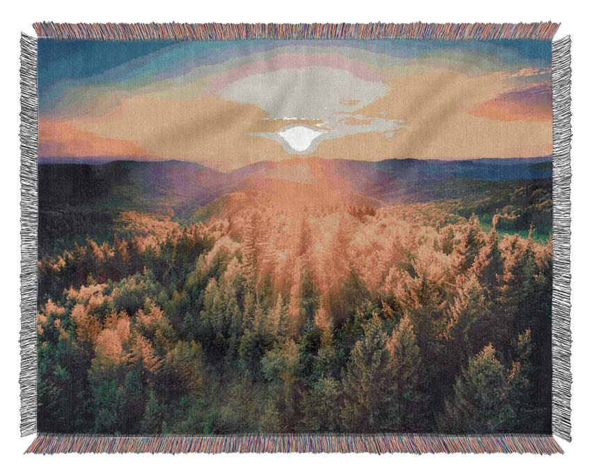 Sunrays over a green woodland Woven Blanket