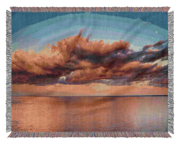 Red glowing clouds above the sea Woven Blanket