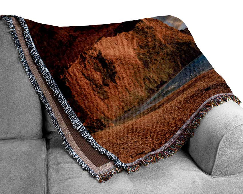 Cave on the coast Woven Blanket