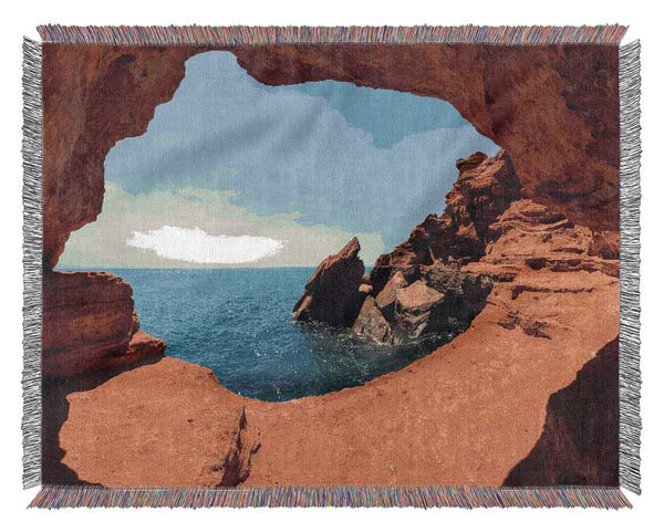 Sea from the view of a cave Woven Blanket