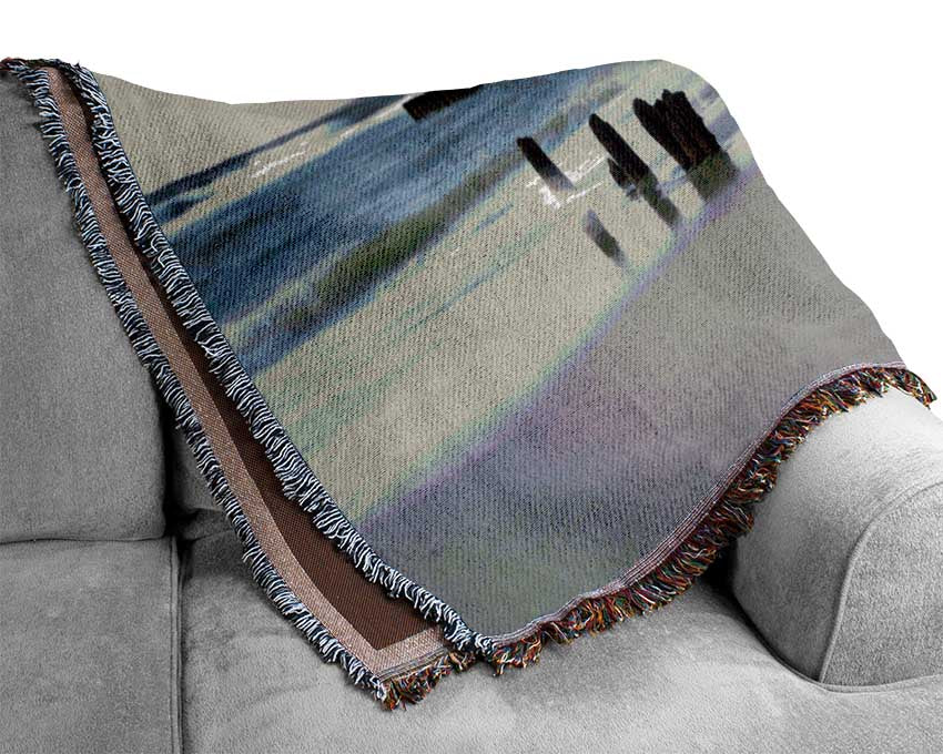 Rough seas on the beach Woven Blanket