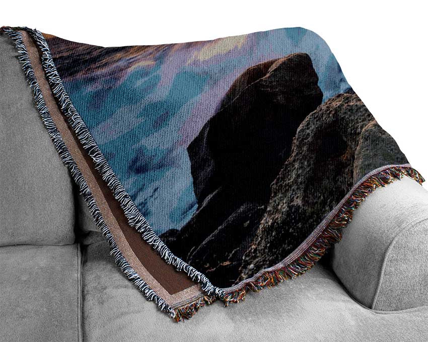 The waves crashing out at sea Woven Blanket