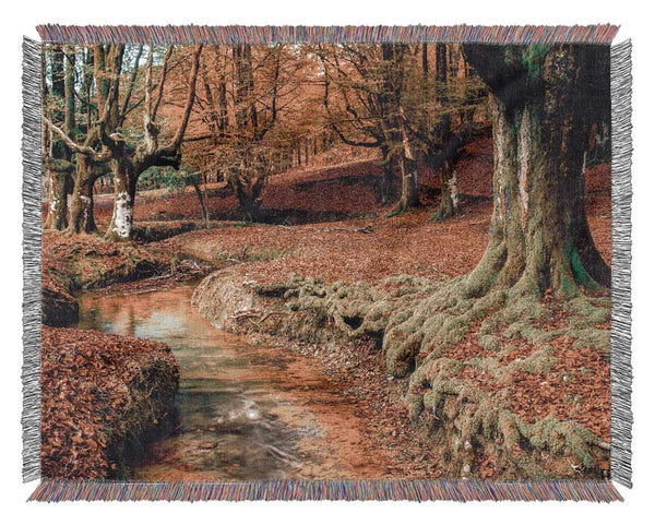 Gentle shallow stream woodland Woven Blanket