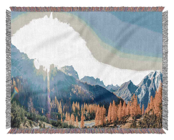 Mountain view of tall trees sunrise Woven Blanket