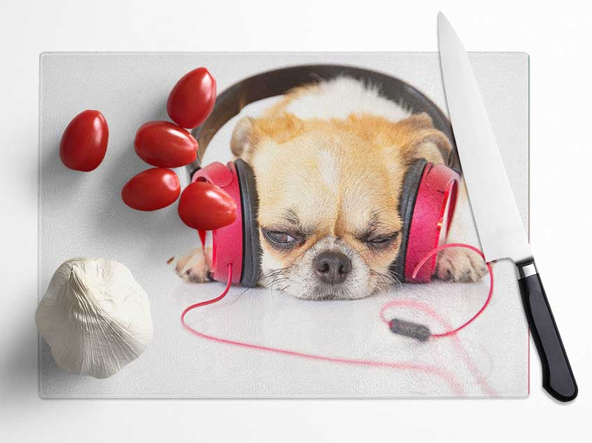 Dog listening to music relaxing Glass Chopping Board