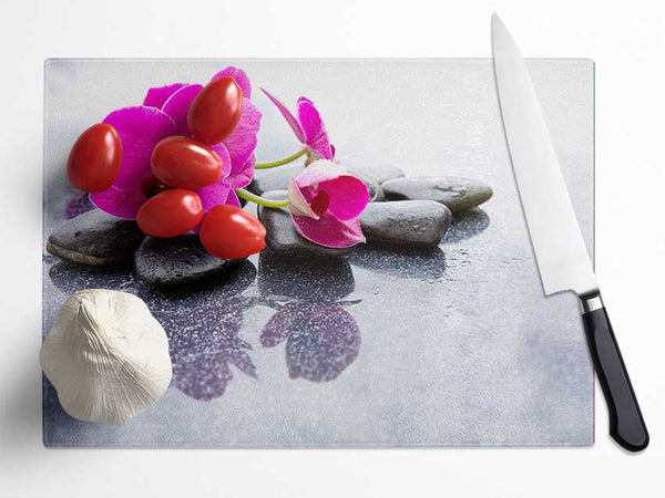 Pink orchid on the rocks Glass Chopping Board