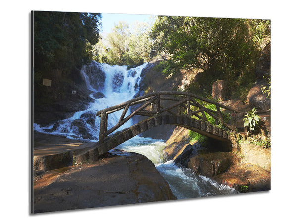 Rustic made bridge by a waterfall