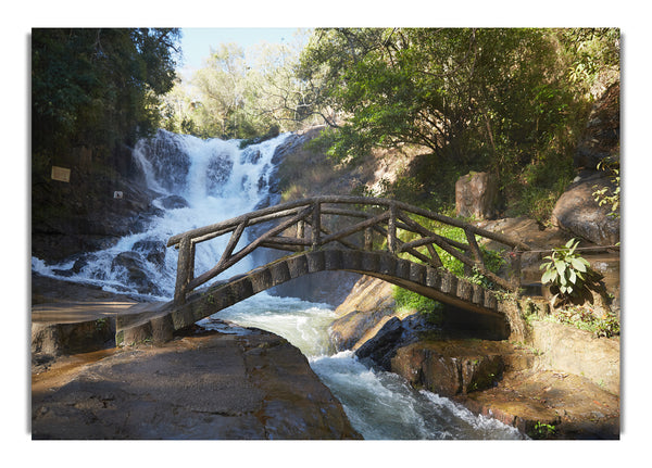 Rustic made bridge by a waterfall