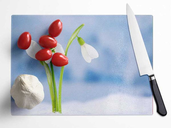 White snowdrops in the snow Glass Chopping Board