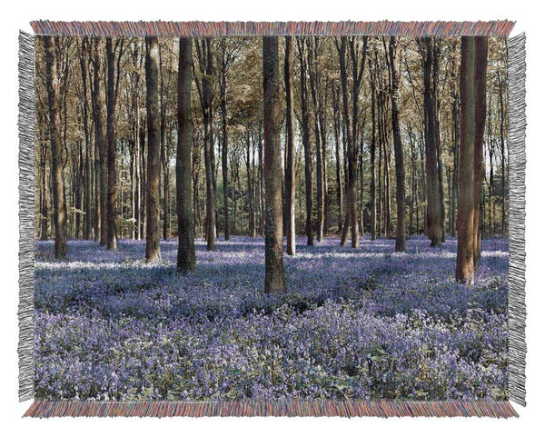 Beautiful purple flowers in the woods Woven Blanket