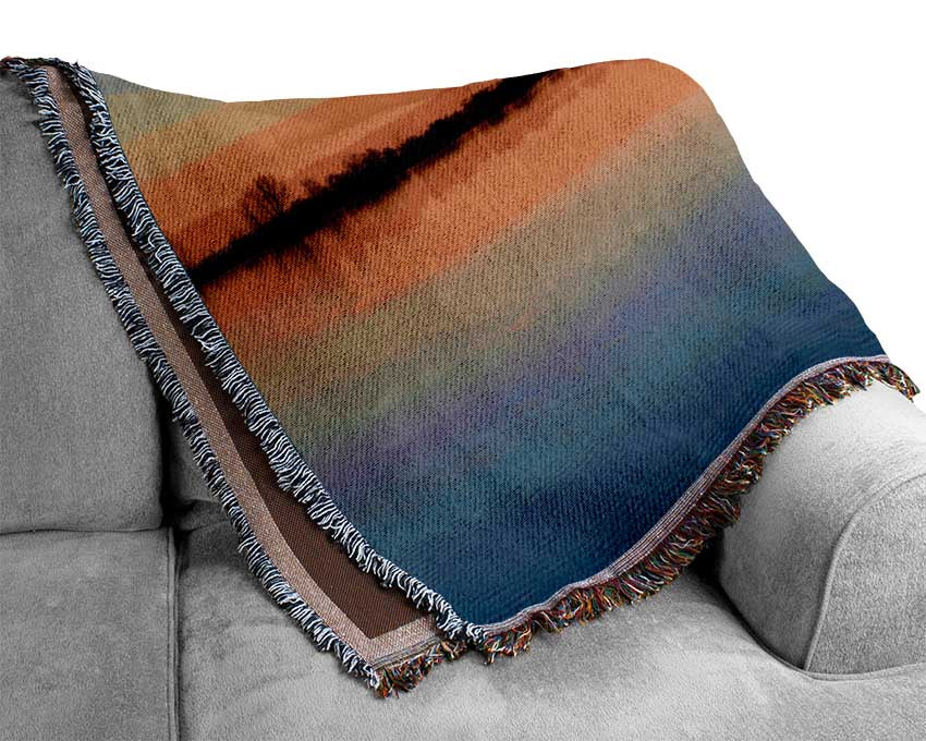 Sunset above the trees river Woven Blanket