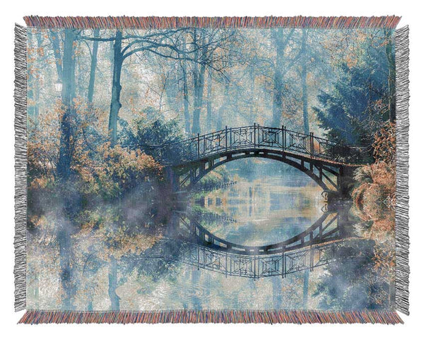 Blue hue bridge on lake Woven Blanket