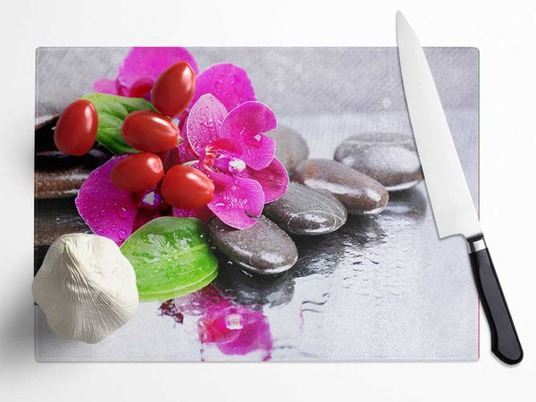 Orchids on the wet pebbles Glass Chopping Board