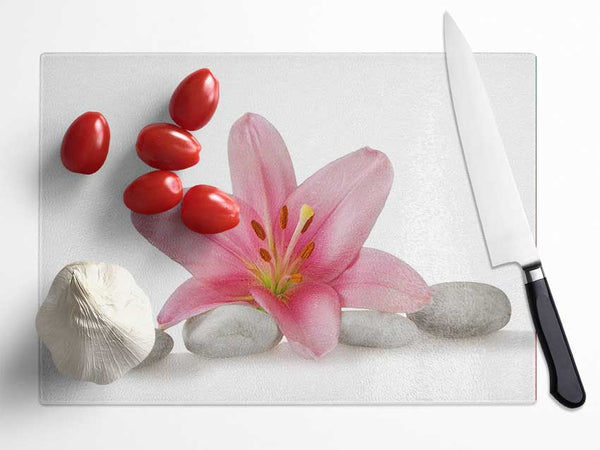 Pink Lilly on grey pebbles Glass Chopping Board