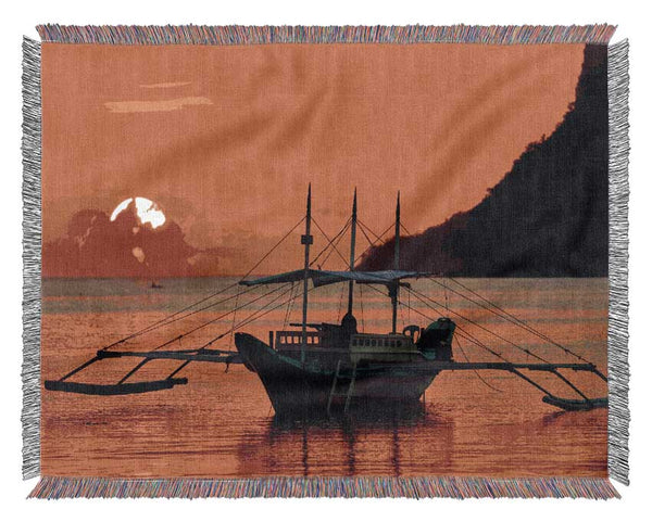 Boat sailing in the orange sunset Woven Blanket