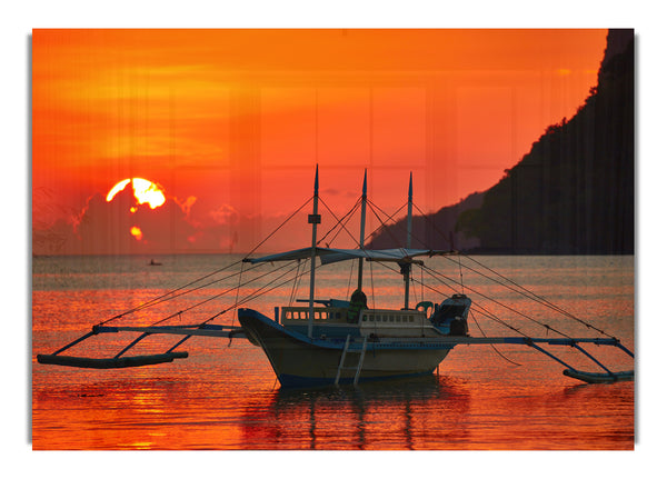 Boat sailing in the orange sunset