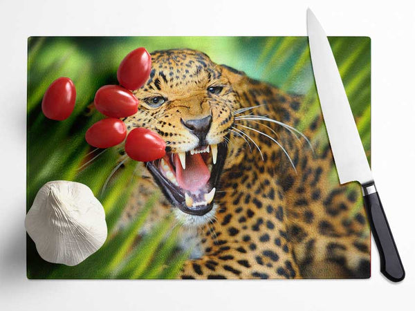 Fierce leopard in the grass Glass Chopping Board