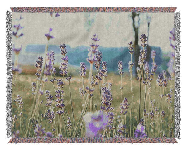 Tiny flowers suspended above the grass Woven Blanket