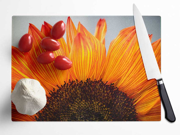 Orange flower opening up close up Glass Chopping Board