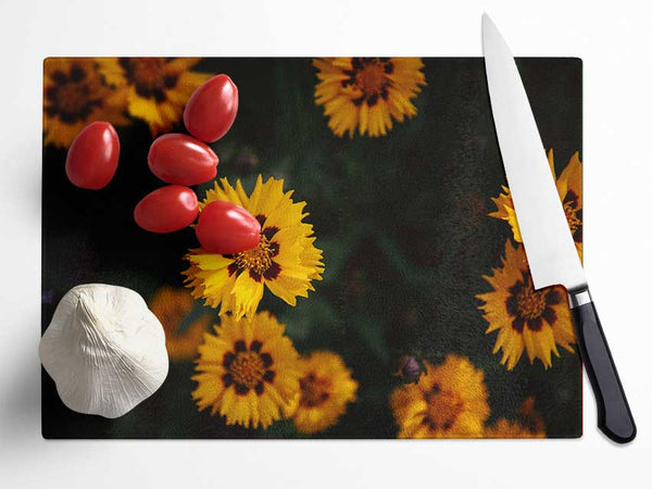 Yellow flowers in the dark Glass Chopping Board