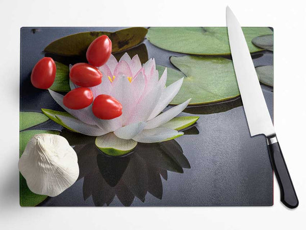 Pond plant floating on the lake Glass Chopping Board