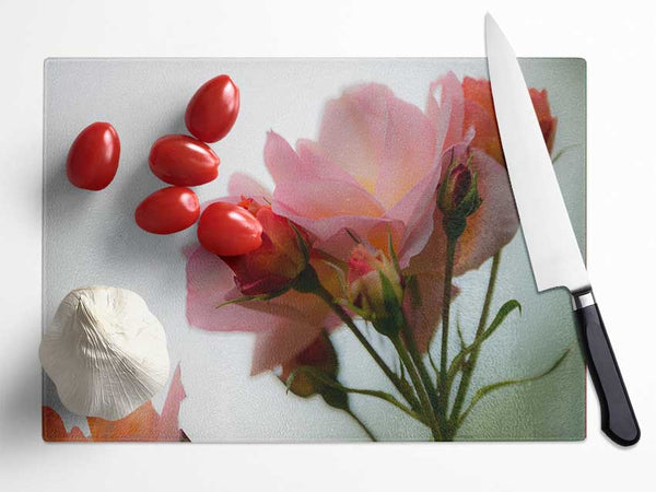 An array of pink flowers Glass Chopping Board